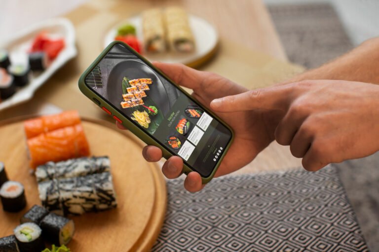 A person reviewing a food order on a mobile delivery app, representing delivery platform integration and technology systems used in cloud kitchen operations.